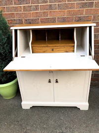a white desk with a wooden top and drawers