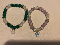 two bracelets with a crown on them
