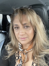 a woman sitting in the back seat of a car