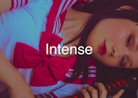 a girl in a sailor suit laying down with a sword