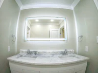 a bathroom with two sinks and a mirror