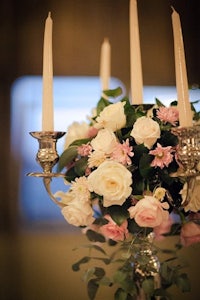 a candle holder with pink and white flowers