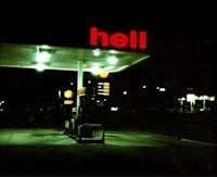 a gas station with a sign that says hell