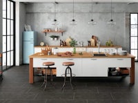 a modern kitchen with a wooden island and stools