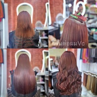 a woman is having her hair done in a salon