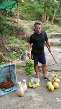 a man standing next to a bunch of bananas