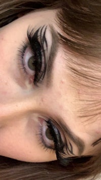 a close up of a woman with long eyelashes