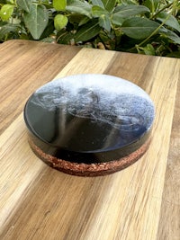 a black and white plate on top of a wooden table