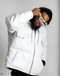 a man wearing a white jacket and glasses