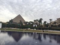 a pool with a pyramid in the background
