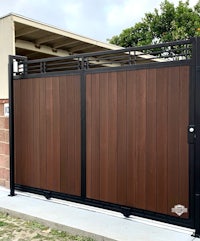 a wooden gate with a black and brown finish