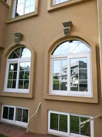 a house with arched windows in front of it