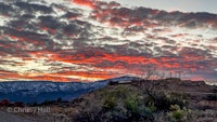 a red and orange sunset over a mountain