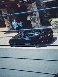 a black car parked on the side of a street