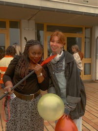 two women posing with balloons