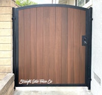 a wooden gate with a black and brown finish