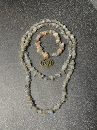 a necklace with labradorite beads and a tarot card