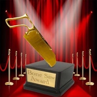 a gold bone saw award on a red carpet