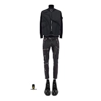 a black jacket with zippers and a pair of jeans