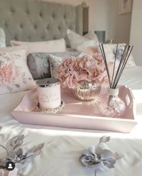 a pink and grey bedroom with a tray of flowers