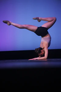 a dancer doing a handstand on a stage