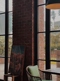 a table and chairs in a room with a large window