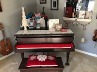 a piano in a room with christmas decorations