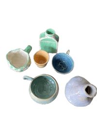 a group of blue and green ceramics on a black background
