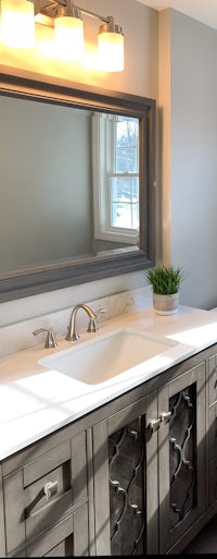a bathroom with a large mirror and sink