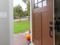 the front door of a home with a pumpkin on it