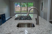a sink in a kitchen with granite counter tops