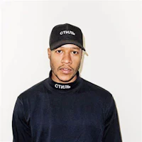 a man wearing a black hat and a black turtleneck