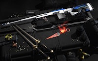 a sniper rifle is sitting on top of a black box