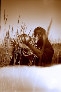 a person holding a frisbee in the grass