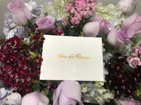 a bouquet of flowers with a note on it