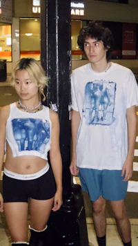 a man and a woman standing next to a street light
