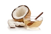 coconut oil and a wooden spoon on a white background