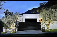 a modern home on a hillside at night