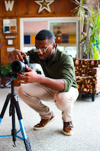 a man is taking a picture with a camera on a tripod