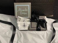 a gift box with a black ribbon and a box of chocolates