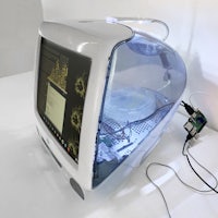 a white computer with a light on it