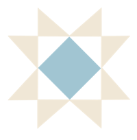 a blue and white quilting star on a black background