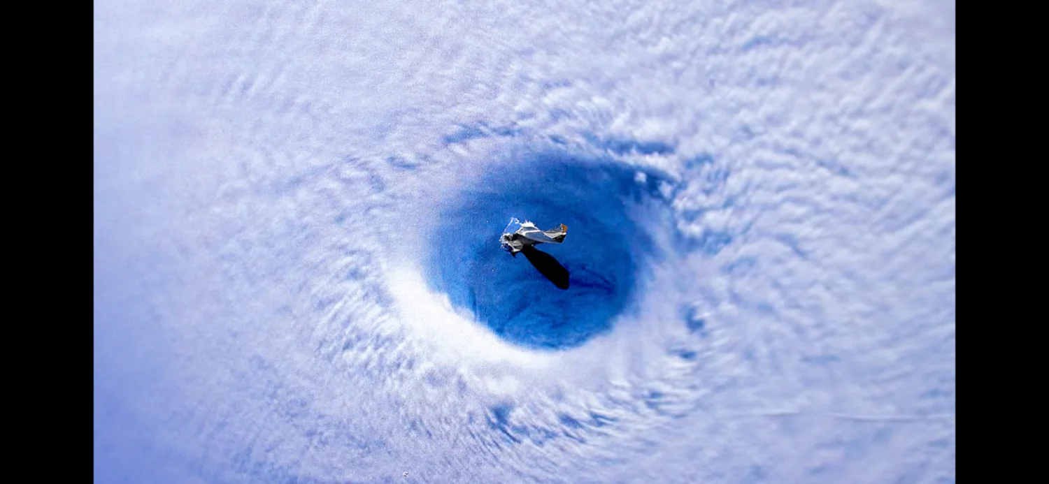 an image of a plane flying over a cloud