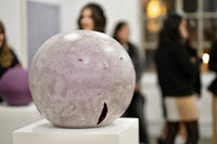 a group of people looking at a sculpture