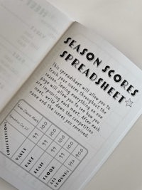 a book with a season scoresheet on it