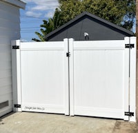 a white gate in front of a house