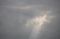 a person is flying a kite in a cloudy sky