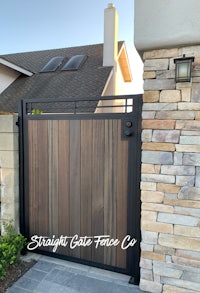 a wooden gate in front of a house