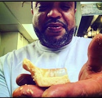 a man holding a piece of pie