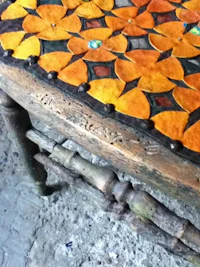a wooden table with orange and yellow flowers on it